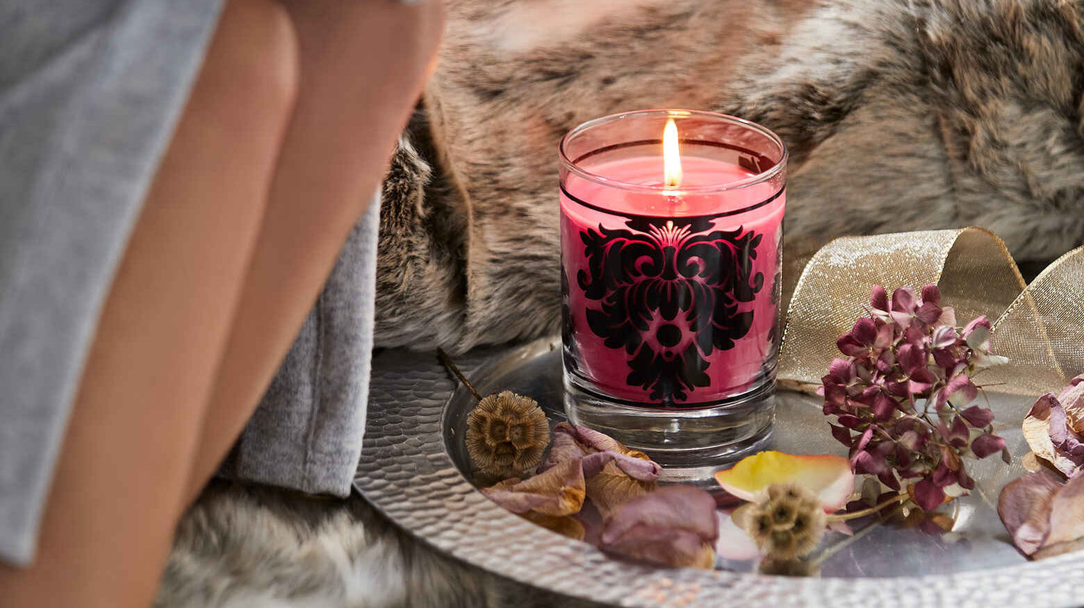 Candle Jar burning on a silver platter.