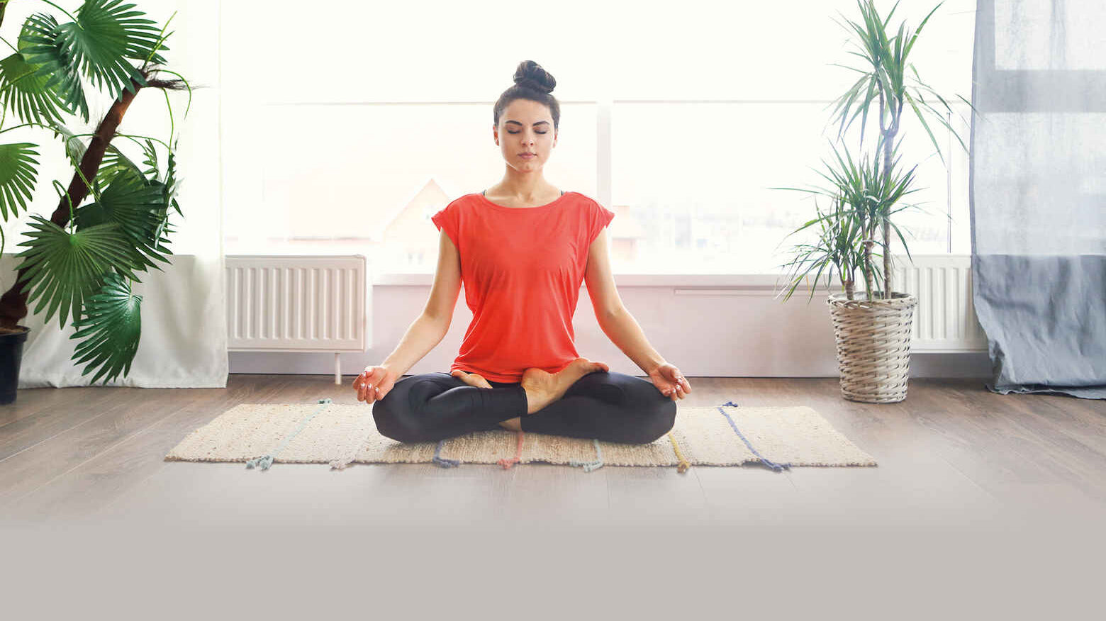 woman in a red shirt in a yoga pose