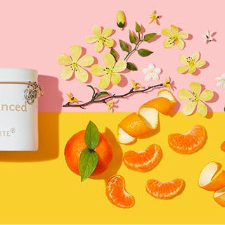 BeBalanced Jar candle on a two toned background with its fragrance notes depicted beside it.