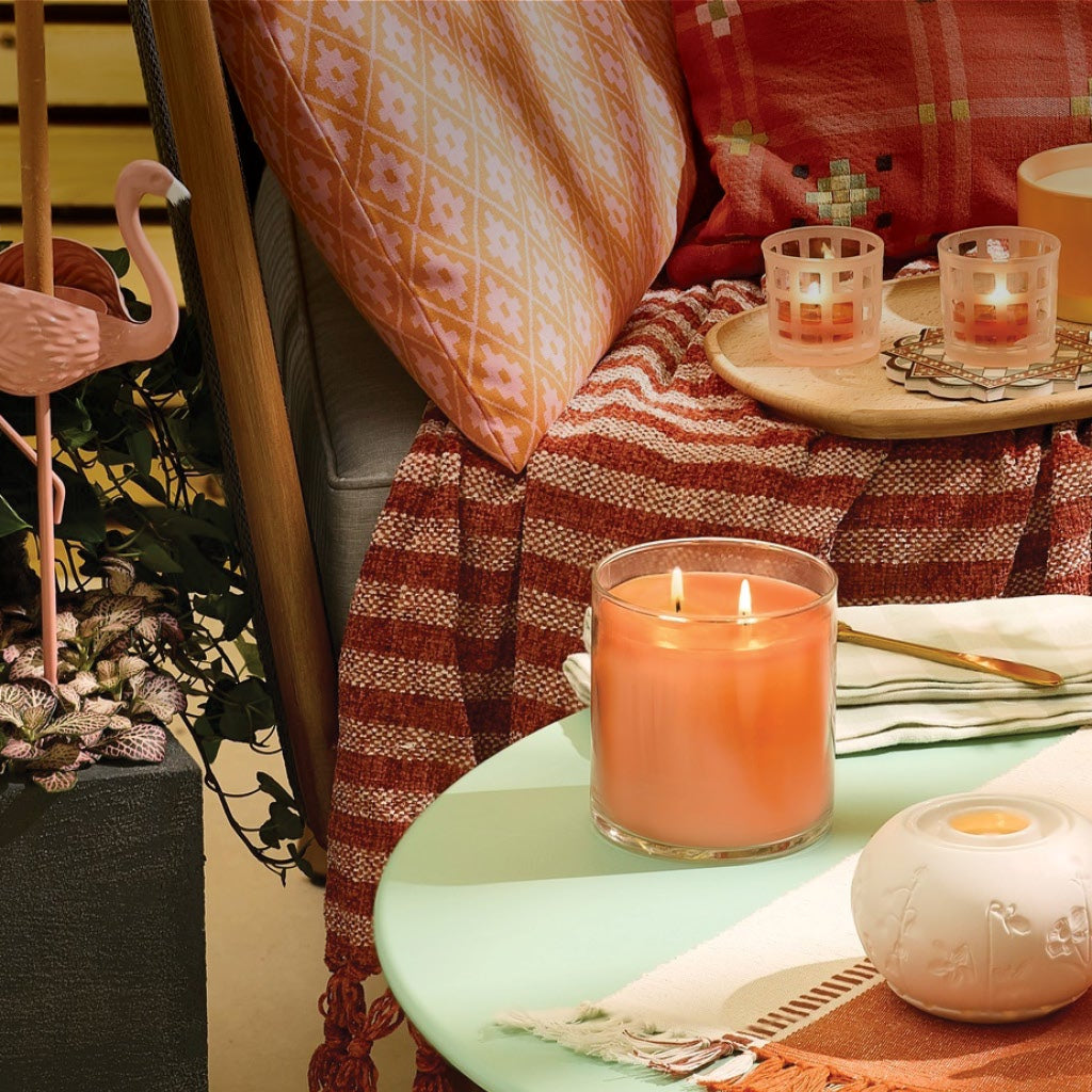 outdoor patio setting with assorted candles and candle holders.