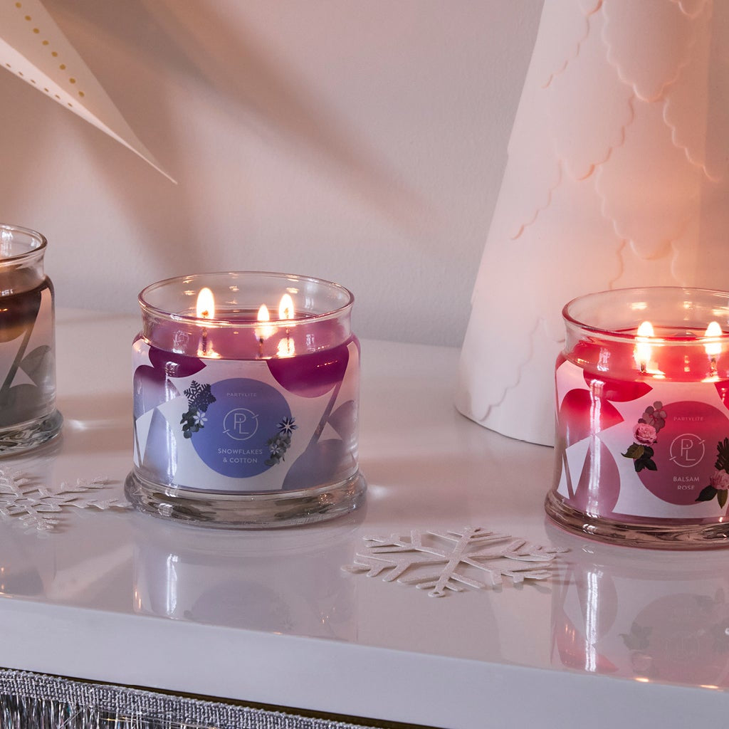PartyLite 3-Wick Jar candles in a winter scene with White decorative trees