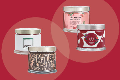 Four candles with different designs on a red background