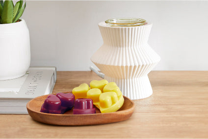 ScentGlow® Warmer – Pinstripes on a table with a tray of melts in front