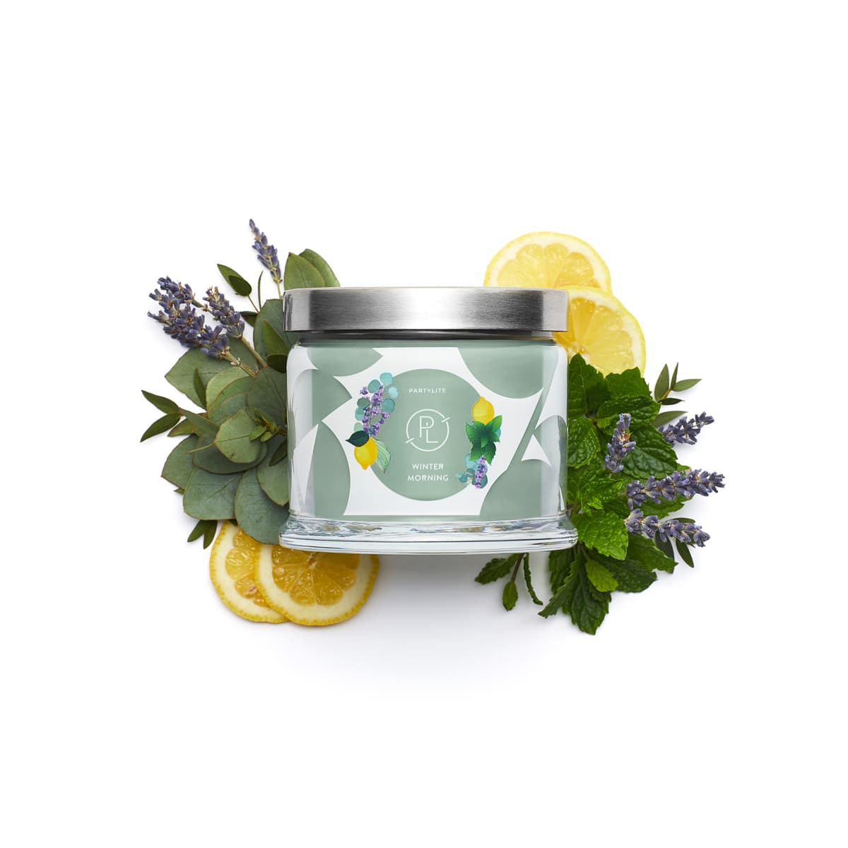 Winter Morning 3-Wick Jar Candle surrounded by sliced lemons and leaves against a white background.