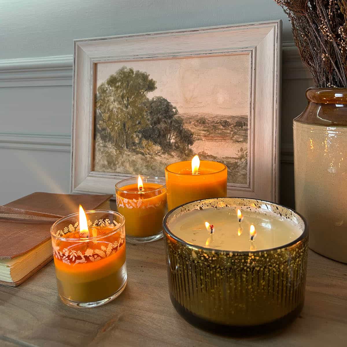 Whiskey & Oak ripple jar candle shown with the Woodland Pumpkin mini jars on a wooden surface.