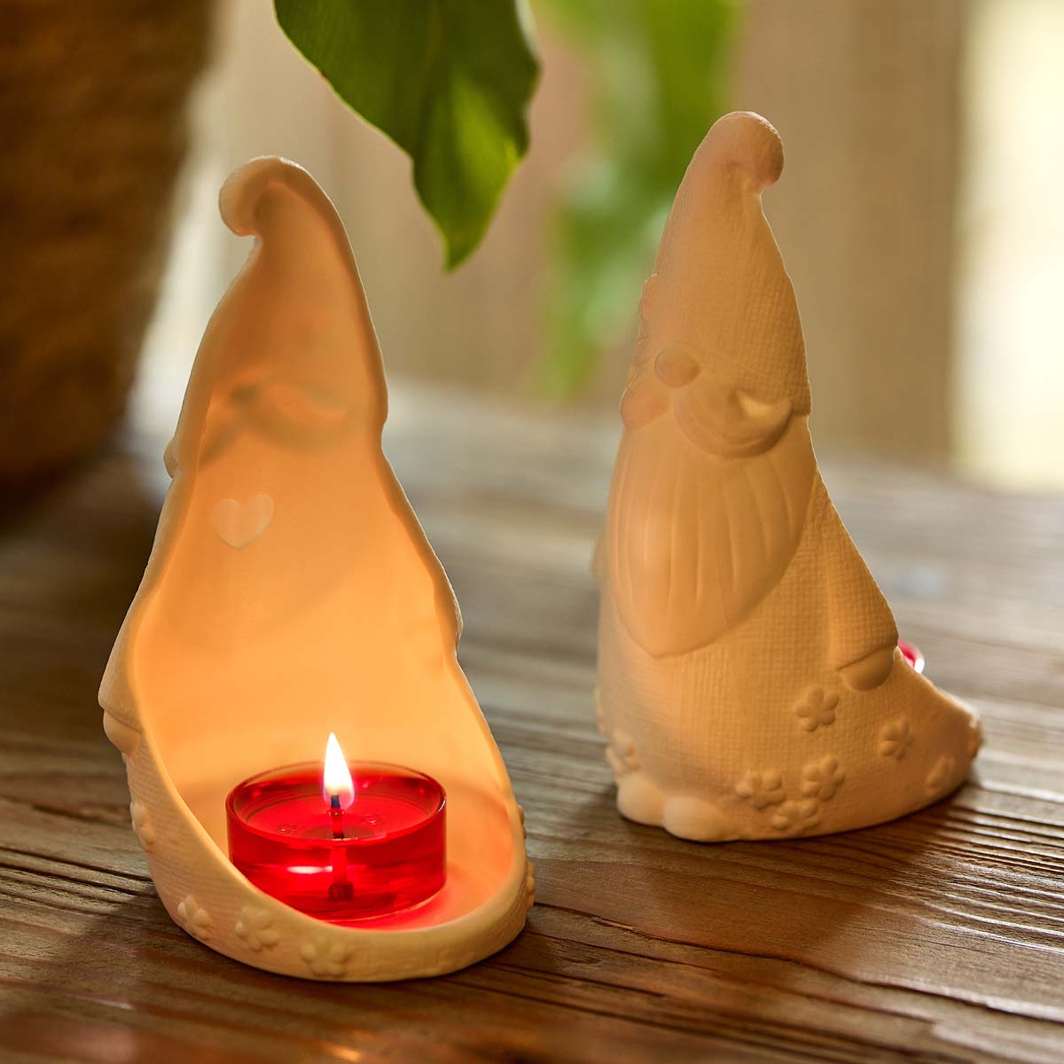 Gnome 'n Garden Tealight Holder Pair shown with a lit tealight on a wooden surface.