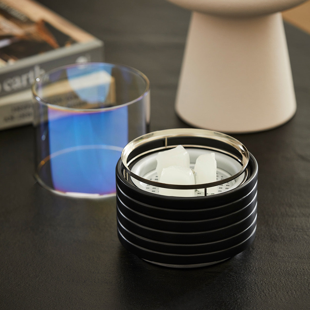 Unscented Petite Flame Melts shown in the Petite Flame on a dark wooden surface