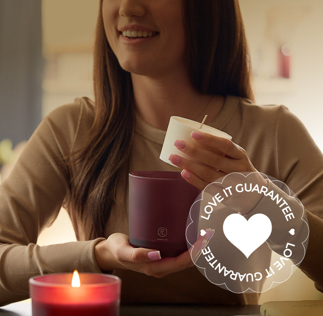 Woman holding a mulberry refillable jar candle and a small white candle refill, with a 'Love It Guarantee' badge overlay.