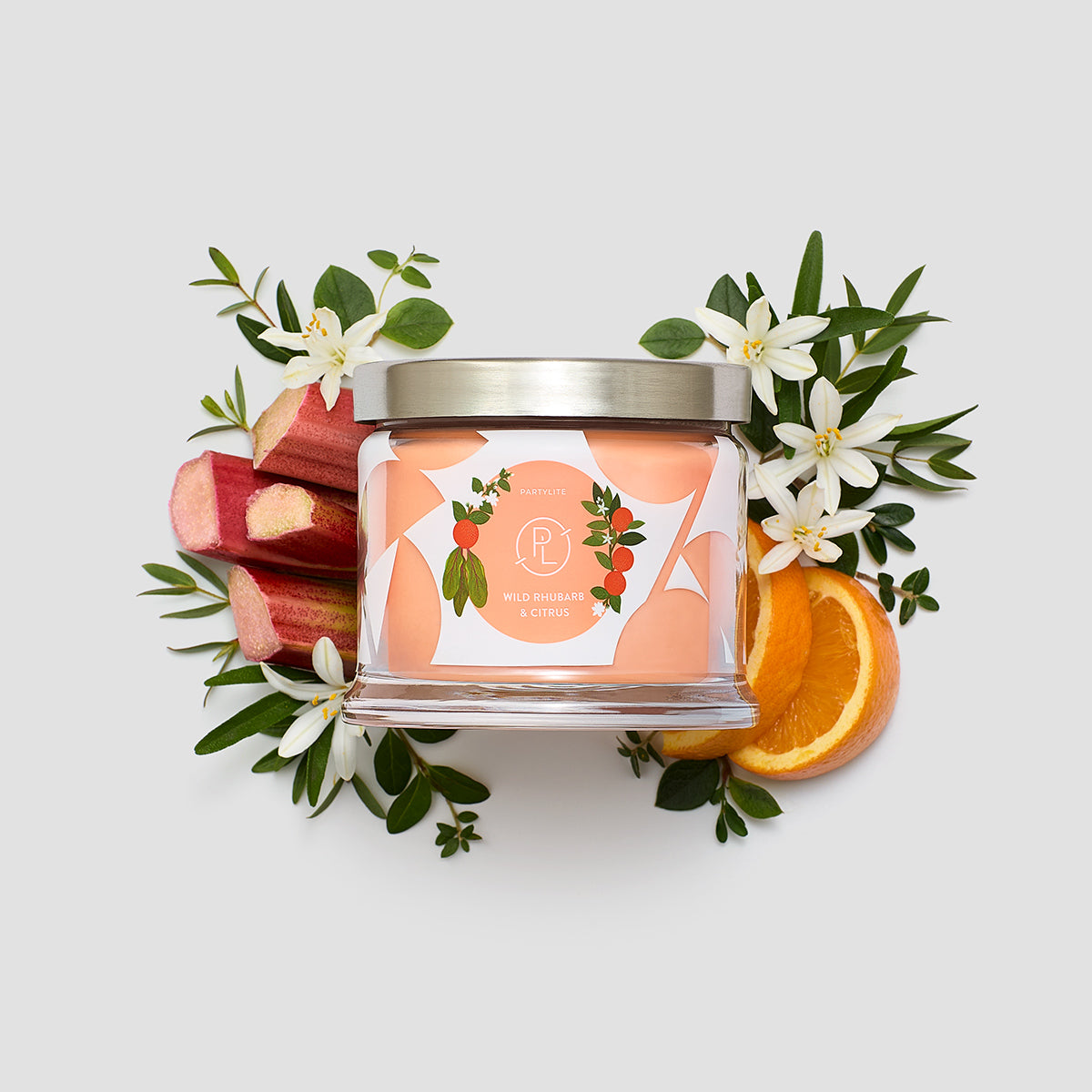Wild Rhubard and Citrus 3-wick Jar candle shown with Rhubard and orange slices against a white background.