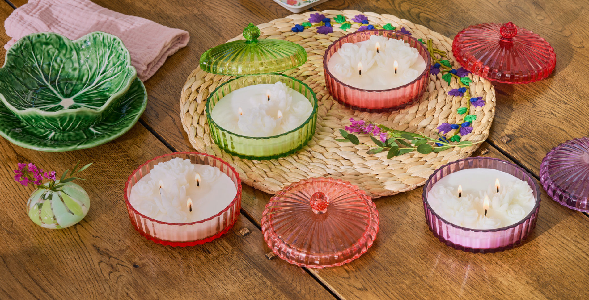 Colorful Garden Party Jar candles on a wooden table.