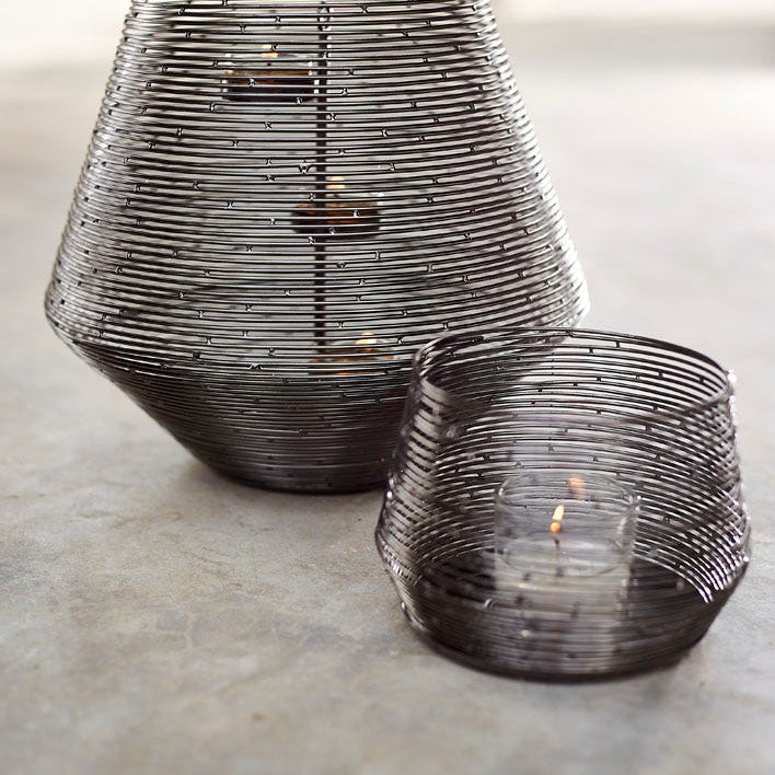 Spun Wire Votive Holder and Hurricane shown together with lit candles.