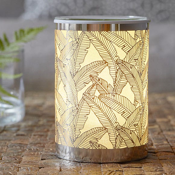 Silver Palm scentglow warmer giving off a warm glow from being switched on.