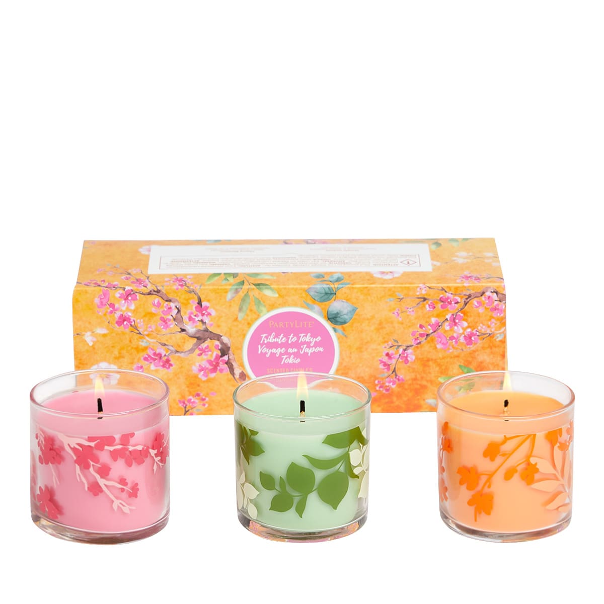 Tribute to Tokyo 3-Piece Jar Candle Sampler, different colored jars, with pink, green and orange wax against a white background.
