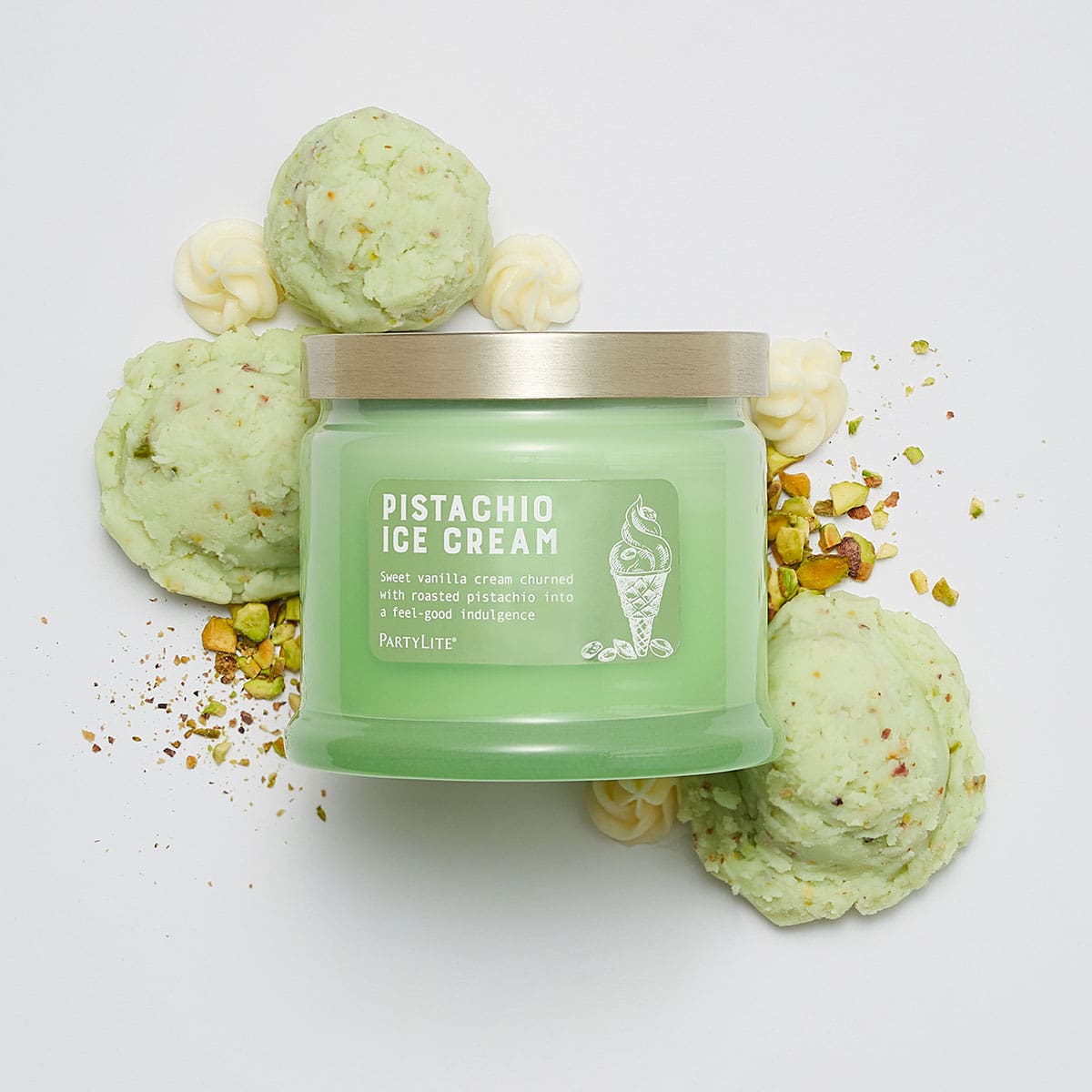 Pistachio Ice Cream 3-Wick Jar Candle in a green color, surrounded by ice cream and crushed pistachios against a white background.