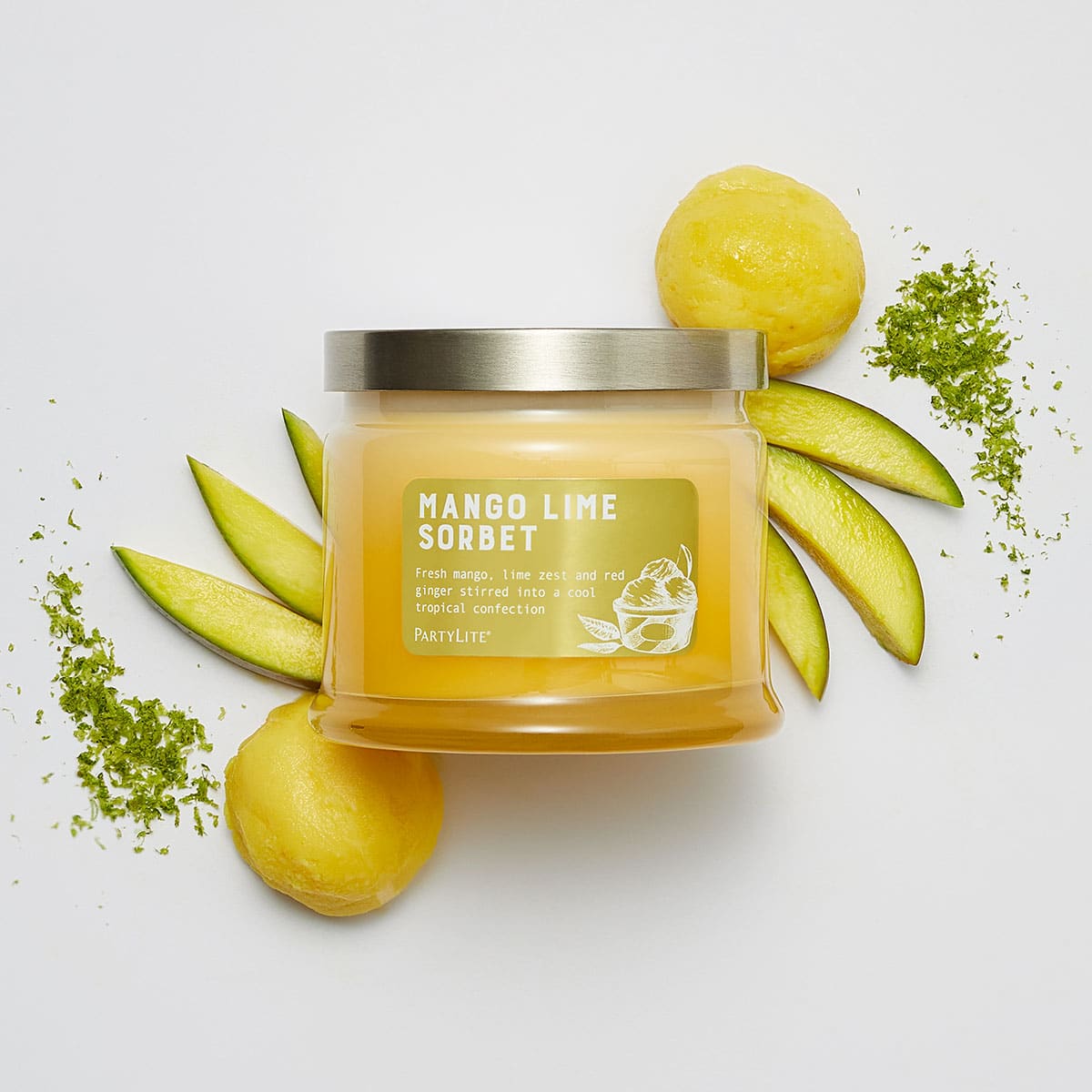 Mango Lime Sorbet 3-Wick Jar Candle surrounded by slices of melon and lemons against a white background.