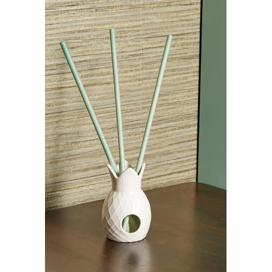 Gardenia Palm Fragrance Sticks in a pineapple shaped white fragrance stick holder on a wooden surface.