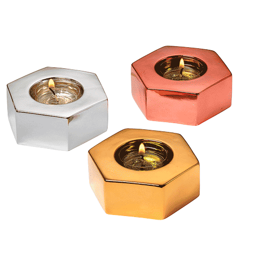 Three hexagonal tealight holders in metallic finishes, silver, rose gold, and gold, displayed against a plain background.