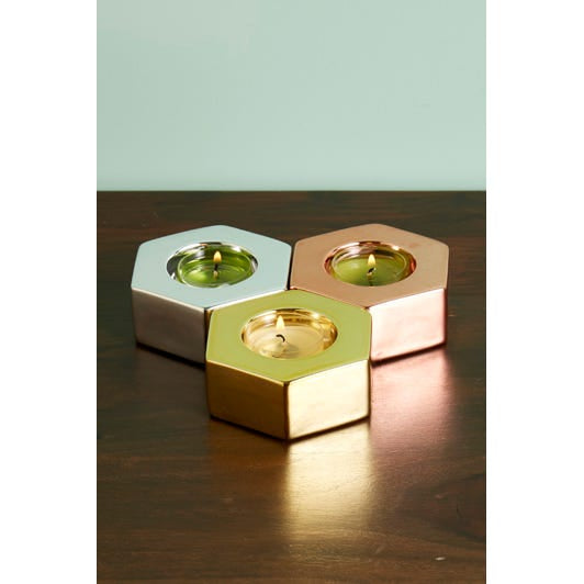 Metallic Hexagon Tealight Trio shown with lit tealights on a wooden surface.
