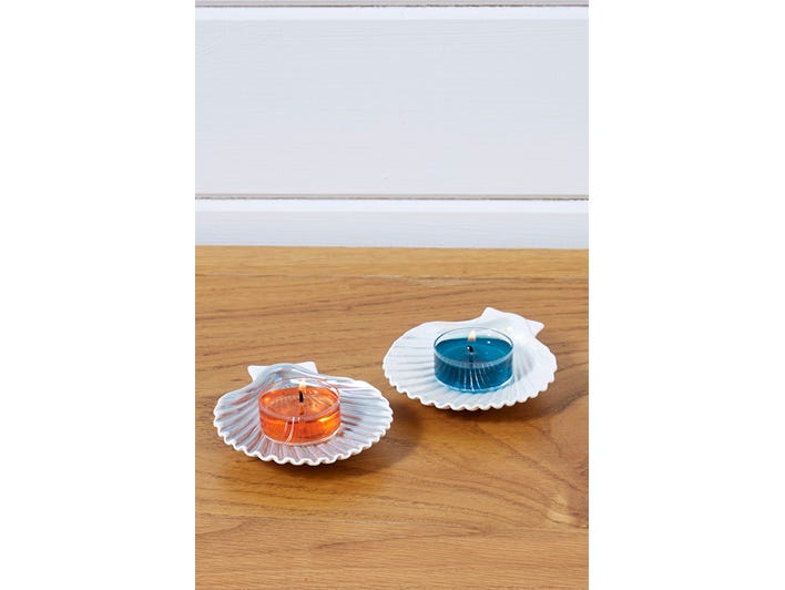 Seashell Tealight Candle Holder Pair shown with lit tealights on a wooden surface.