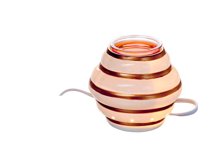 Queens Hive scentglow warmer against a white background.