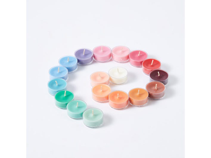 Various colored tealights against a white background.