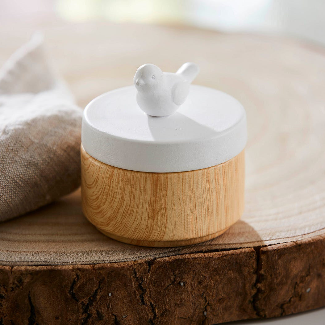 Spring Pals Tealight Candle Holder Trio wooden bases with white lids.
On this lid a bird and the tealight holder shown on a wooden surface.