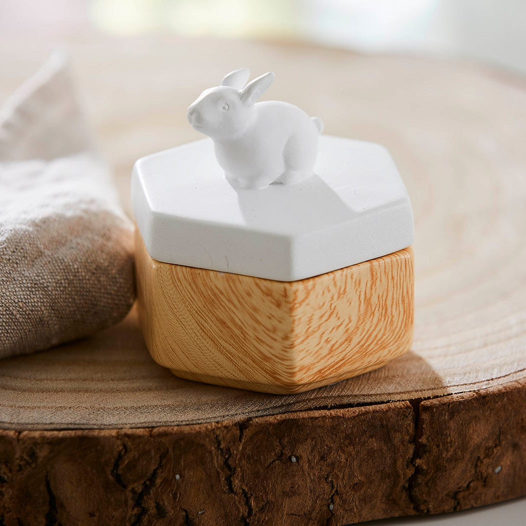 Spring Pals Tealight Candle Holder Trio wooden bases with white lids.
On this lid a rabiit and the tealight holder shown on a wooden surface.