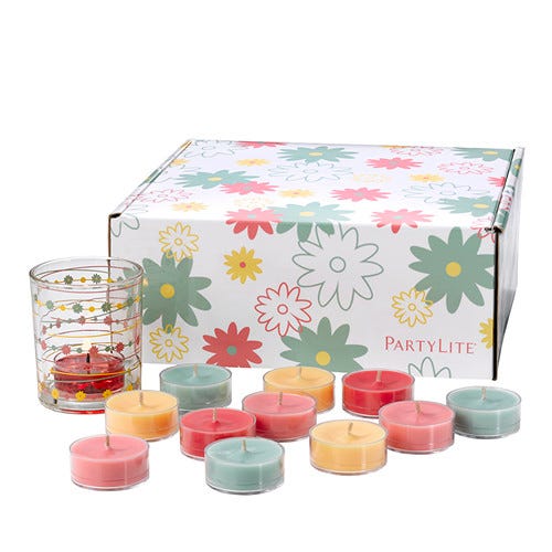 From the Garden Tealight Holder Gift Set, white box with different colored flowers, with a clear glass tealight holder with string a of colorful flowers circling the jar, shown with various colored tealights against a white background.