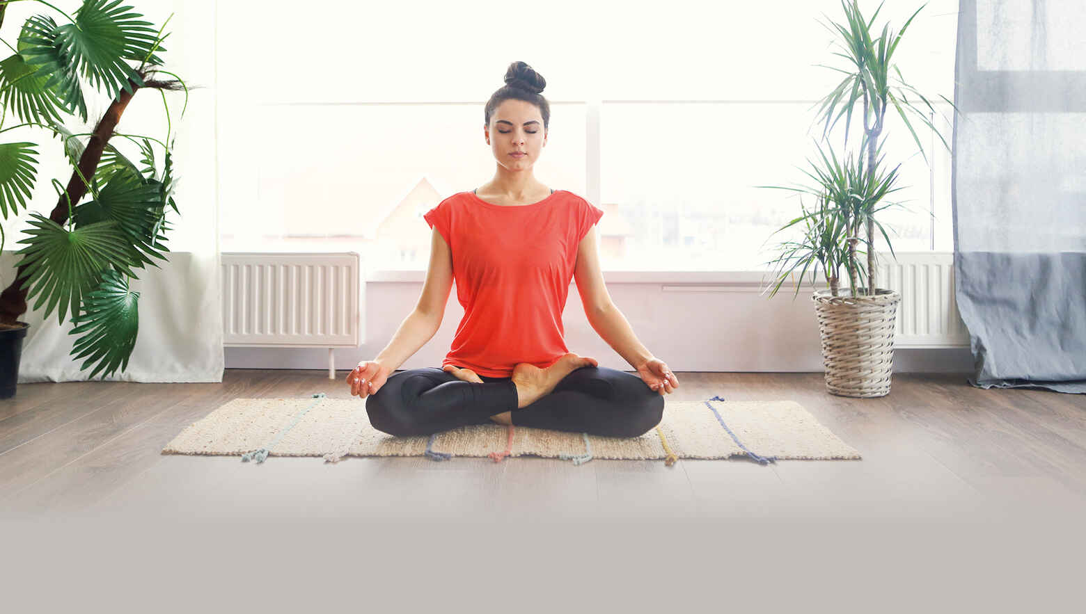 woman in a red shirt in a yoga pose