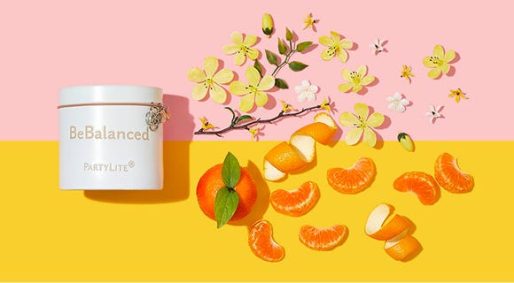 BeBalanced Jar candle on a two toned background with its fragrance notes depicted beside it. 