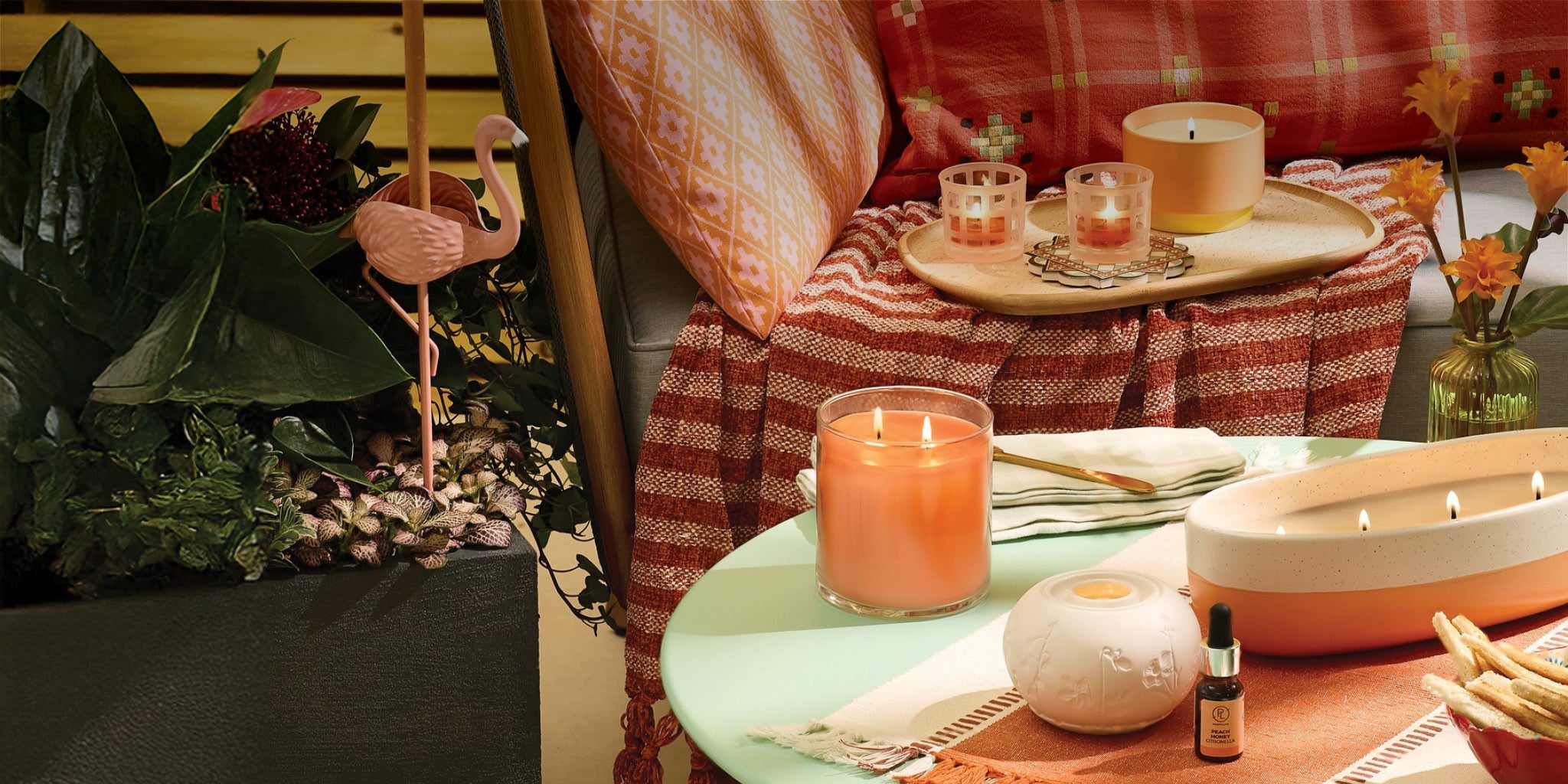 outdoor patio setting with assorted candles and candle holders.