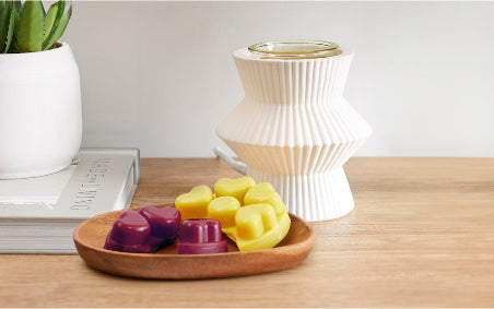 ScentGlow® Warmer – Pinstripes on a table with a tray of melts in front