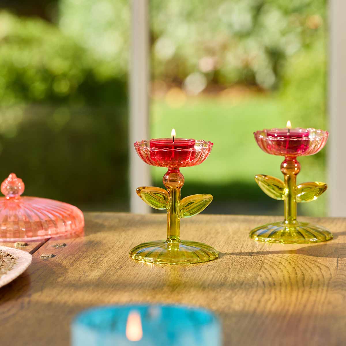 Dainty Flowers Tealight Holder Pair with lit tealights on a wooden surface.