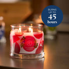 Juicy Strawberry Lemongrass 3-Wick Jar Candle shown lit with a blue circle with text stating the burn times.