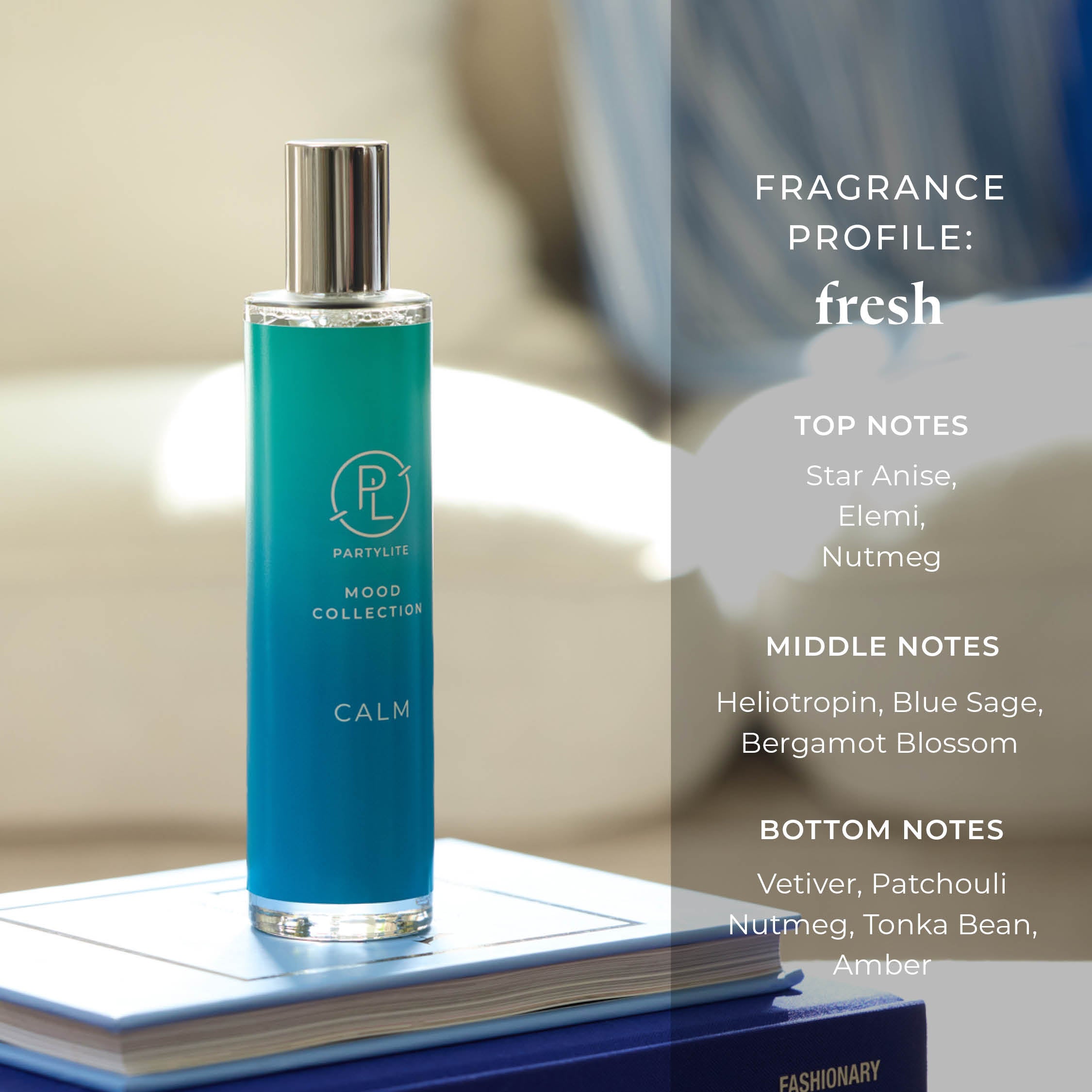 Blue room spray bottle labelled 'Calm' on a book with fragrance profile details.