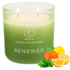 Green candle labelled 'Renewed' from  Mood Collection with fruits and mint leaves on a white background.