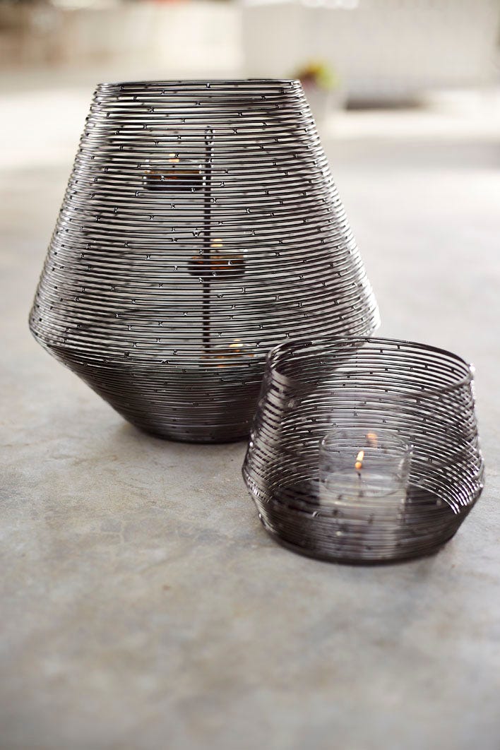 Spun Wire Votive Holder and Hurricane shown together with lit candles.