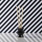 Black Pinstripes Fragrance Holder shown with fragrance sticks against a black and white strippy background.