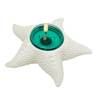White Starfish Tealight Holder shown with a lit tealight candle.