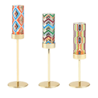 Tribal Chic Raised Tealight Holder Trio in colorful patterns on gold stands.