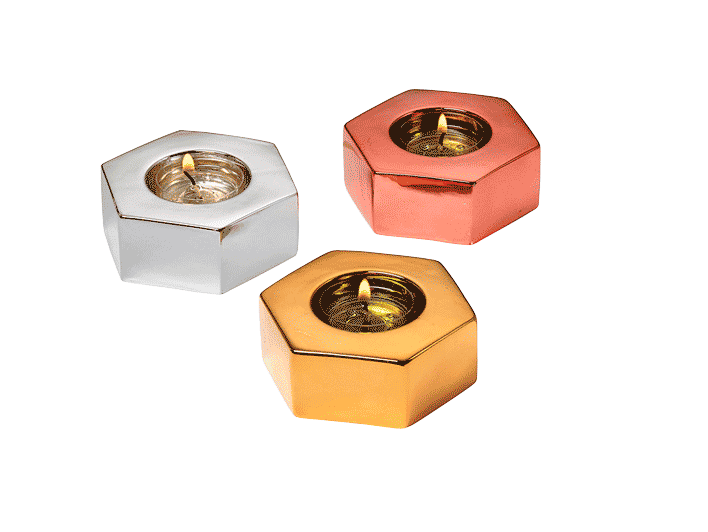 Three hexagonal tealight holders in metallic finishes, silver, rose gold, and gold, displayed against a plain background.