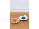 Seashell Tealight Candle Holder Pair shown with lit tealights on a wooden surface.