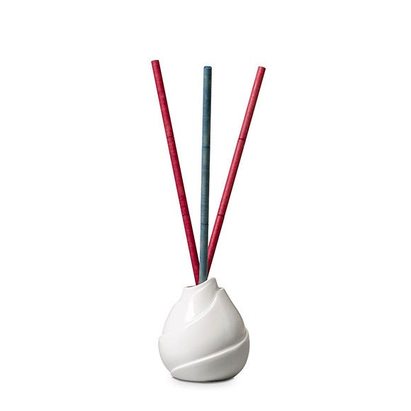 White Waves Fragrance stick holder, against a white background, with red and green fragrance sticks.