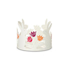 Hoppity white Jar Candle Holder with rabbits shapes and colorful  flower heads, against a white background.