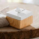 Spring Pals Tealight Candle Holder Trio wooden bases with white lids. 
On this lid a butterfly and the tealight holder shown on a wooden surface.